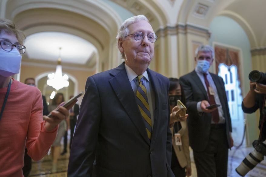 Senate Minority Leader Mitch McConnell, R-Ky., is surrounded by journalists as he walks to the Senate Chamber for a vote as Democrats look for a way to lift the debt limit without Republican votes, at the Capitol in Washington, Wednesday, Oct. 6, 2021. (AP Photo/J. Scott Applewhite)