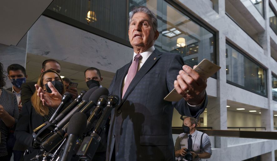Sen. Joe Manchin, D-W.Va., a key holdout vote on President Joe Biden&#x27;s domestic agenda, makes a statement to reporters about Republicans and Democrats resolving their fight over raising the debt limit, at the Capitol in Washington, Wednesday, Oct. 6, 2021. (AP Photo/J. Scott Applewhite)