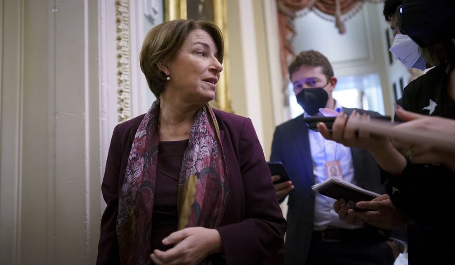 Sen. Amy Klobuchar, D-Minn., chair of Senate Democratic Steering Committee, stops for questions by reporters after meeting with White House officials to work on a way to lift the debt limit without Republican votes, at the Capitol in Washington, Wednesday, Oct. 6, 2021. (AP Photo/J. Scott Applewhite)