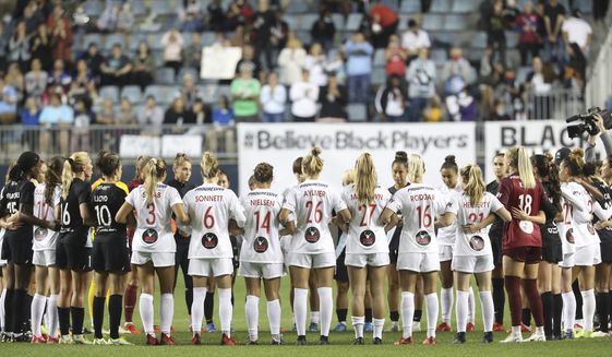 Washington Spirit and NJ/NY Gotham FC players cause a stoppage midway through the first half and gather in unity for U.S. women&#39;s team players, during an NWSL soccer match Wednesday, Oct. 6, 2021, in Chester, Pa. (Charles Fox/The Philadelphia Inquirer via AP)