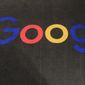 In this Nov. 18, 2019, file photo, the logo of Google is displayed on a carpet at the entrance hall of Google France in Paris. A new search feature rolled out Wednesday, Oct. 6, 2021, tells users which flights have lower carbon emissions, giving them the ability to choose flights based on carbon emissions just as they would price or the number of layovers. (AP Photo/Michel Euler, File)