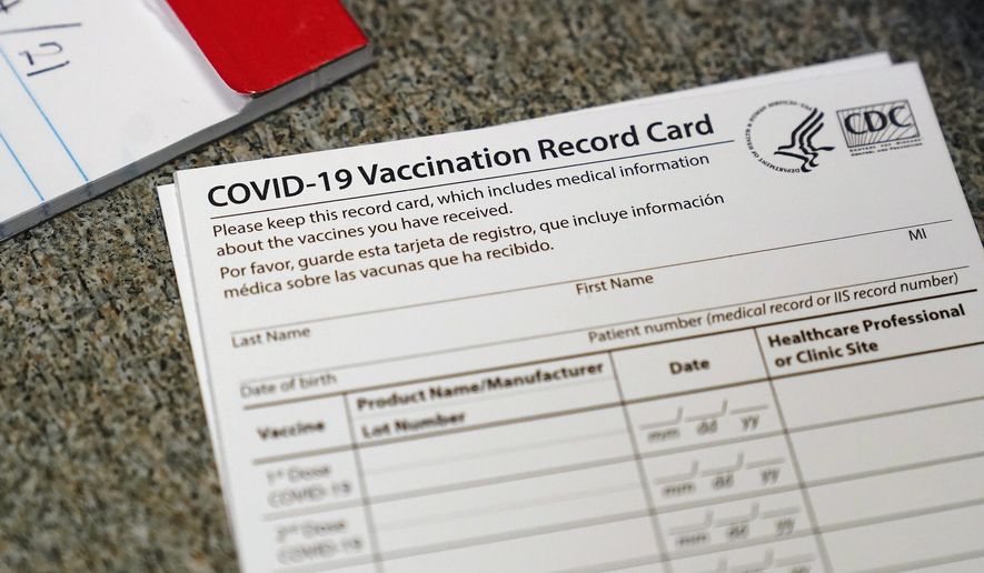 FILE - In this Dec. 24, 2020, file photo, a COVID-19 vaccination record card is shown at Seton Medical Center in Daly City, Calif. Los Angeles leaders are poised to enact one of the nation&#39;s strictest vaccine mandates, a sweeping measure that would require the shots for everyone entering a bar, restaurant, nail salon, gym or even a Lakers game. The City Council on Wednesday, Oct. 6, 2021, is scheduled to consider the proposal and most members have said they support it as a way of preventing further COVID-019 surges. (AP Photo/Jeff Chiu, File)