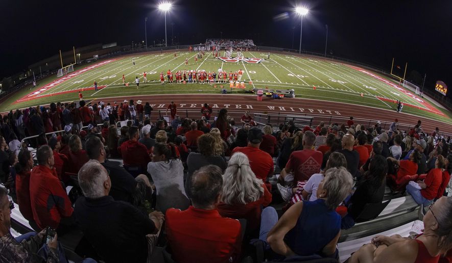 Fans fill the stadium at the football field at Whitewater High School on Friday, Oct. 1, 2021, in Whitewater, Wis. A growing number of school districts in the U.S. are using federal pandemic funding on athletics projects. When school officials at Whitewater learned they would be getting $2 million in pandemic relief this year, they decided to set most of it aside to cover costs from their current budget, freeing up $1.6 million in local funding that’s being used to build new synthetic turf fields for football, baseball and softball. (AP Photo/Morry Gash)