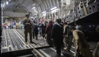In this Aug. 22, 2021, photo provided by the U.S. Air Force, Afghan passengers board a U.S. Air Force C-17 Globemaster III during the Afghanistan evacuation at Hamid Karzai International Airport in Kabul, Afghanistan. (MSgt. Donald R. Allen/U.S. Air Force via AP) **FILE**