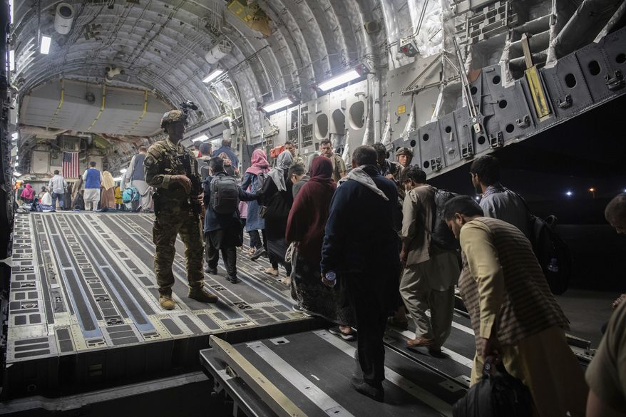 In this Aug. 22, 2021, photo provided by the U.S. Air Force, Afghan passengers board a U.S. Air Force C-17 Globemaster III during the Afghanistan evacuation at Hamid Karzai International Airport in Kabul, Afghanistan. (MSgt. Donald R. Allen/U.S. Air Force via AP) **FILE**