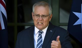 Australia&#39;s Prime Minister Scott Morrison speaks during a press conference in Canberra, Thursday, Oct. 7, 2021. Morrison has described social media as a &amp;quot;coward&#39;s palace&amp;quot; and warned digital platforms such as Facebook could be held liable for defamatory comments posted anonymously. (Lukas Coch/AAP Image via AP)