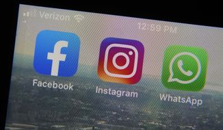 This Tuesday, Oct. 5, 2021 file photo shows the mobile phone app logos for, from left, Facebook, Instagram and WhatsApp in New York. A bipartisan Senate proposal introduced Thursday would require social media platforms to give researchers access to internal data with the intent of giving the public a peek behind the curtain of how prominent tech platforms do business. (AP Photo/Richard Drew, File)