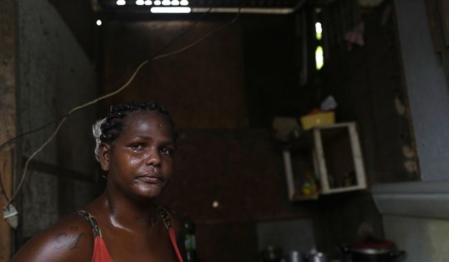 Francielle de Santana cries as she explains that some days her family doesn&#x27;t have food to eat, at their home in the Jardim Gramacho favela of Rio de Janeiro, Brazil, Monday, Oct. 4, 2021. Surging inflation on food and electricity are affecting the poor, with rising gas prices forcing some to cook with firewood and alcohol. (AP Photo/Silvia Izquierdo)