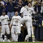 Milwaukee Brewers&#x27; Rowdy Tellez celebrates a two-run home run with Willy Adames during the seventh inning in Game 1 of baseball&#x27;s National League Divisional Series against the Atlanta Braves Friday, Oct. 8, 2021, in Milwaukee.(AP Photo/Aaron Gash)