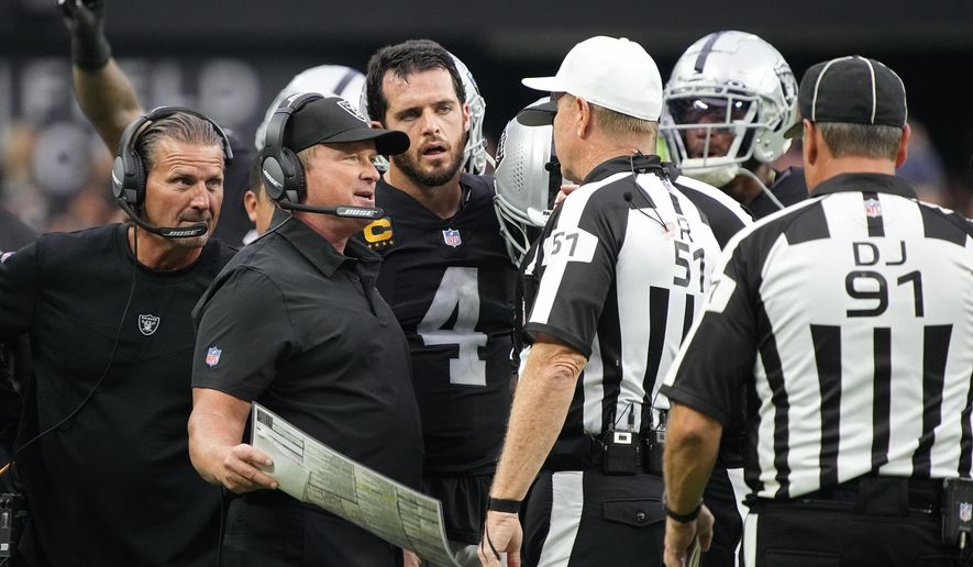Las Vegas Raiders head coach Jon Gruden speaks with officials during the second half of an NFL football game against the Miami Dolphins, Sunday, Sept. 26, 2021, in Las Vegas. (AP Photo/Rick Scuteri) **FILE**