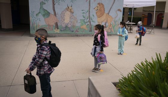 In this April 13, 2021, file photo, socially distanced kindergarten students wait for their parents to pick them up on the first day of in-person learning at Maurice Sendak Elementary School in Los Angeles. (AP Photo/Jae C. Hong) ** FILE **