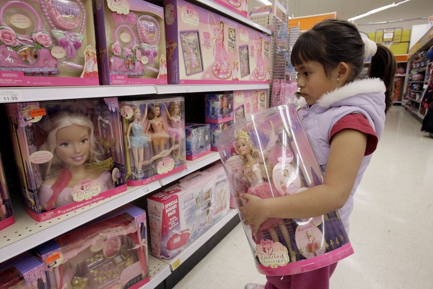 FILE - In this Jan. 29, 2007, file photo Yvette Ibarra holds a Dancing Princess Barbie doll while shopping at a toy store in Monrovia, Calif. California is the first state to require large department stores to display products like toys and toothbrushes in gender-neutral ways. Gov. Gavin Newsom signed the law Saturday, Oct. 9, 2021. It does not outlaw traditional boys and girls sections at department stores. Instead, it says large stores must also have a gender-neutral section. (AP Photo/Nick Ut, File)