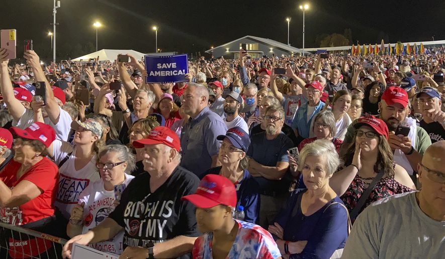 People wait for a rally with former President Donald Trump to begin at the Iowa State Fairgrounds in Des Moines, Iowa., Saturday, Oct. 9, 2021. (AP Photo/Thomas Beaumont)