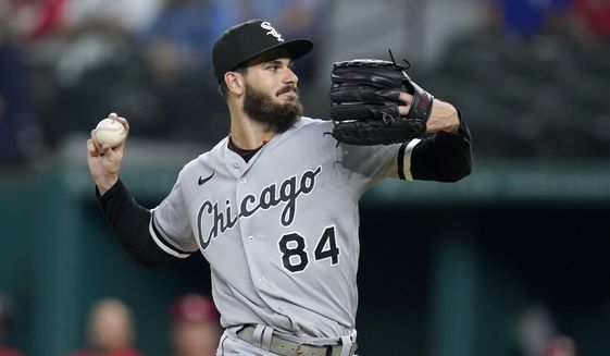 Chicago White Sox starting pitcher Dylan Cease winds up to throw to a Texas Rangers batter during the first inning of a baseball game in Arlington, Texas, Friday, Sept. 17, 2021. (AP Photo/Tony Gutierrez)