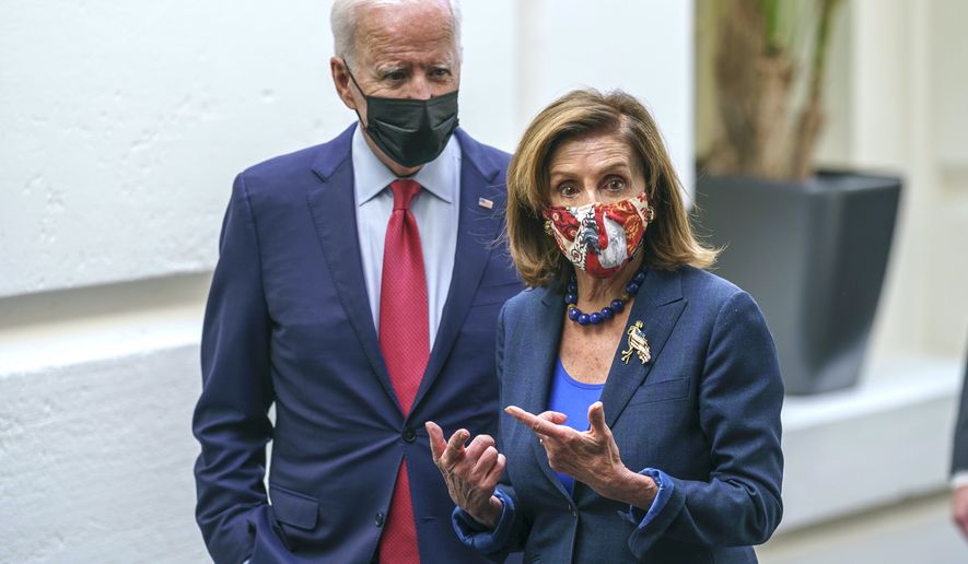 President Joe Biden and Speaker of the House Nancy Pelosi, D-Calif., talk in a basement hallway of the Capitol after meeting with House Democrats to rescue his $3.5 trillion government overhaul and salvage a related public works bill, in Washington, Friday, Oct. 1, 2021. (AP Photo/J. Scott Applewhite)