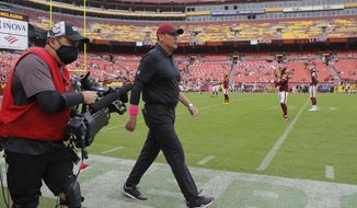 Washington Football Team head coach Ron Rivera walks on the field before an NFL football game against the New Orleans Saints, Sunday, Oct. 10, 2021, in Landover, Md. (AP Photo/Julio Cortez)