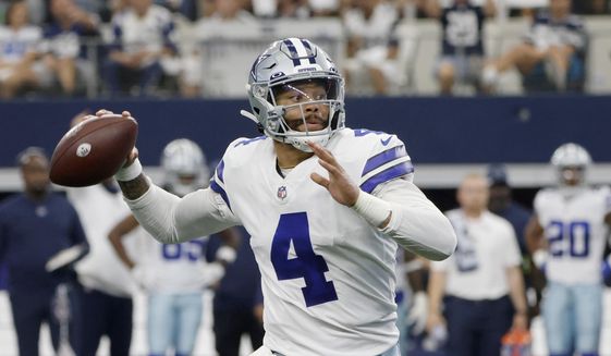 Dallas Cowboys quarterback Dak Prescott scrambles before throwing a pass in the first half of an NFL football game against the New York Giants in Arlington, Texas, Sunday, Oct. 10, 2021. (AP Photo/Michael Ainsworth)