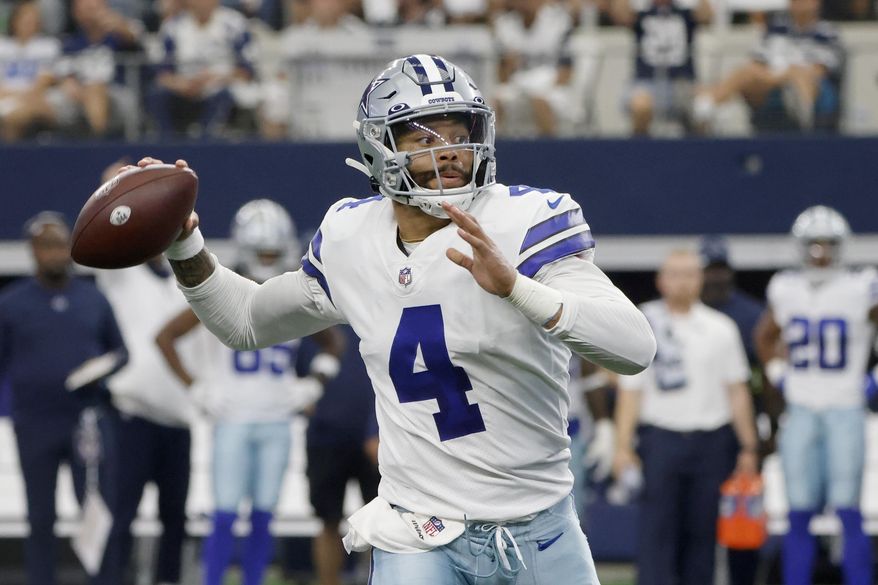 Dallas Cowboys quarterback Dak Prescott scrambles before throwing a pass in the first half of an NFL football game against the New York Giants in Arlington, Texas, Sunday, Oct. 10, 2021. (AP Photo/Michael Ainsworth)