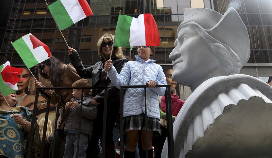 FILE - In this Oct. 8, 2012 file photo, people ride on a float with a large bust of Christopher Columbus during the Columbus Day parade in New York.  Monday, Oct. 11, 2021 federal holiday dedicated to Christopher Columbus continues to divide those who view the explorer as a representative of Italian Americans’ history and those horrified by an annual tribute that ignores the native people whose lives and culture were forever changed by colonialism.(AP Photo/Seth Wenig, File)