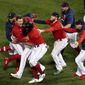 The Boston Red Sox celebrate after beating the Tampa Bay Rays on a sacrifice fly ball by Enrique Hernandez (5) during the ninth inning during Game 4 of a baseball American League Division Series, Monday, Oct. 11, 2021, in Boston. The Red Sox won 6-5. (AP Photo/Michael Dwyer)
