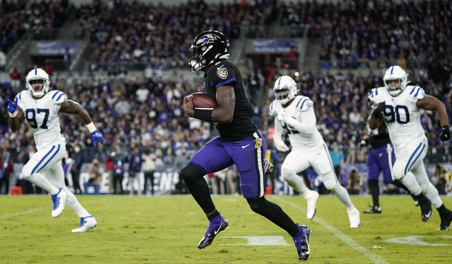 Baltimore Ravens quarterback Lamar Jackson (8) scrambles away from Indianapolis Colts defenders during the first half of an NFL football game, Monday, Oct. 11, 2021, in Baltimore. (AP Photo/Julio Cortez)