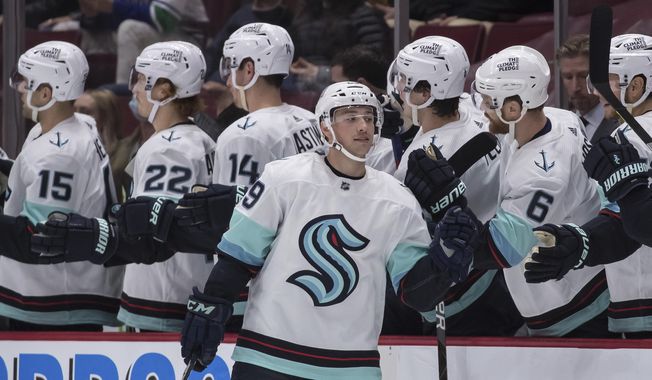 Seattle Kraken&#x27;s Vince Dunn (29) celebrates his first goal against the Vancouver Canucks during the second period of an NHL preseason hockey game, Tuesday, Oct. 5, 2021 in Vancouver, British Columbia (Darryl Dyck/The Canadian Press via AP) **FILE**