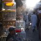 Afghans walk through a market in Kabul, Afghanistan, Tuesday, Oct. 12, 2021. (AP Photo/Ahmad Halabisaz)