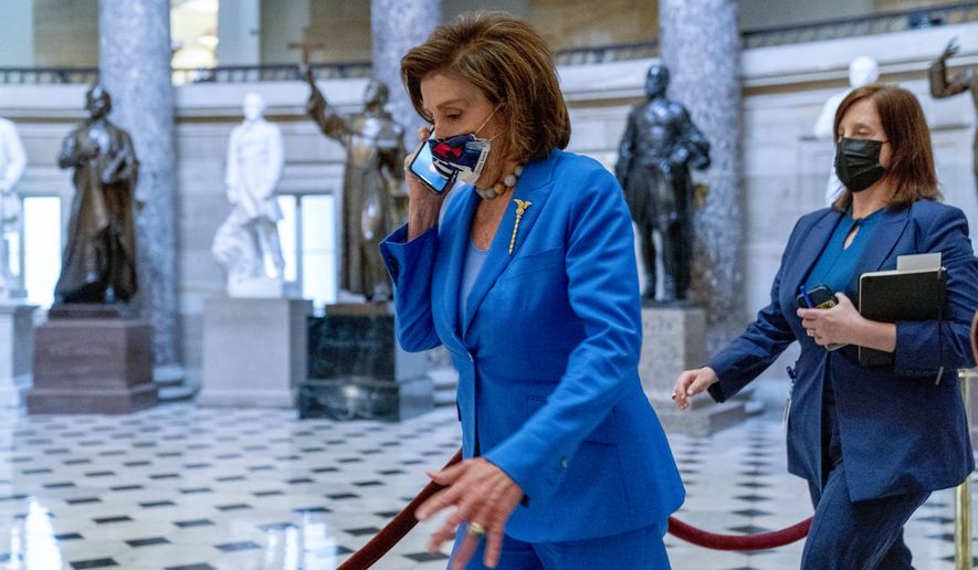 House Speaker Nancy Pelosi of Calif., walks towards the House Chamber to convene the House for legislative business at the Capitol in Washington, Tuesday, Oct. 12, 2021. The House is expected to vote to increase the debt limit later this afternoon. (AP Photo/Andrew Harnik)