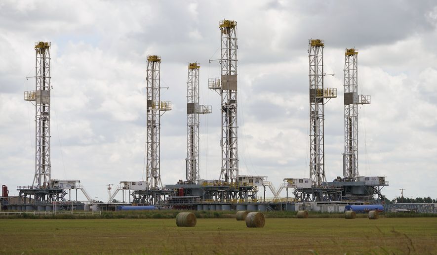 Drilling rigs stand idle Wednesday, June 30, 2021, in Calumet, Okla., as Oklahoma&#x27;s drilling for new gas and oil wells is down from recent years. (AP Photo/Sue Ogrocki)