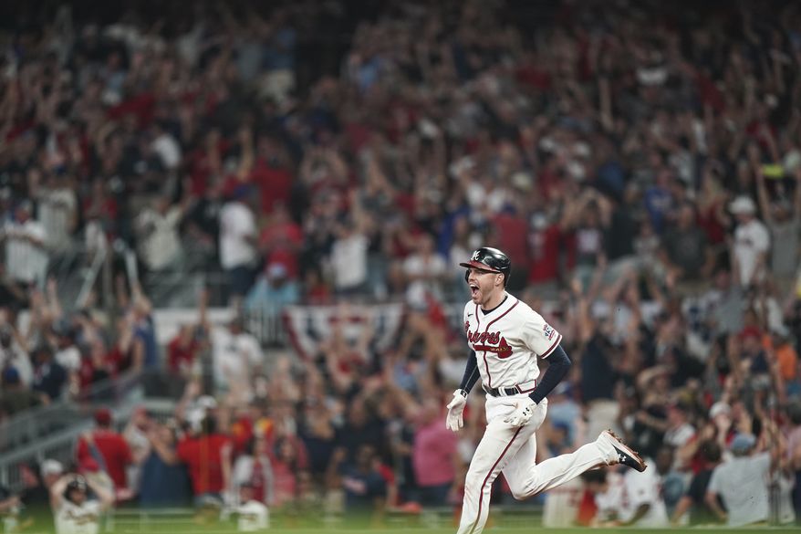 Atlanta Braves&#39; Freddie Freeman (5) celebrates his solo homerun during the eighth inning of Game 4 of a baseball National League Division Series against the Milwaukee Brewers, Tuesday, Oct. 12, 2021, in Atlanta. (AP Photo/Brynn Anderson)