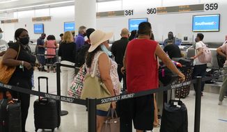 Southwest passengers wait to check in at Miami International Airport, Tuesday, Oct. 12, 2021, in Miami. Southwest Airlines appears to be fixing problems that caused the cancellation of nearly 2,400 flights over the previous three days. By midday Tuesday, Southwest had canceled fewer than 100 flights, although more than 400 others were running late. (AP Photo/Marta Lavandier)