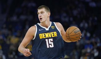 Denver Nuggets center Nikola Jokic dribbles aduring the first half of the team&#x27;s preseason NBA basketball game against the Golden State Warriors in San Francisco, Wednesday, Oct. 6, 2021. (AP Photo/Jeff Chiu) **FILE**