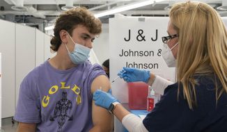 In this July 30, 2021, file photo, Bradley Sharp, of Saratoga, N.Y., gets the Johnson &amp;amp; Johnson vaccine from registered nurse Stephanie Wagner in New York. (AP Photo/Mark Lennihan, File)
