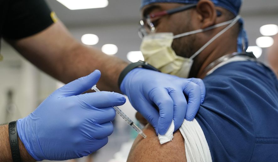 A health care worker receives a Pfizer COVID-19 booster shot at Jackson Memorial Hospital Tuesday, Oct. 5, 2021, in Miami. (AP Photo/Lynne Sladky) ** FILE **