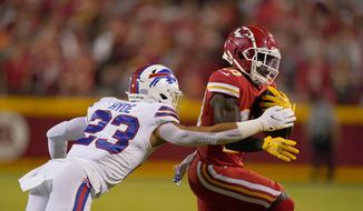 Kansas City Chiefs wide receiver Tyreek Hill, right, runs with the ball as Buffalo Bills safety Micah Hyde defends during the first half of an NFL football game Sunday, Oct. 10, 2021, in Kansas City, Mo. (AP Photo/Charlie Riedel) **FILE**