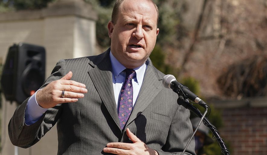 In this March 10, 2021, file photo, Colorado Gov. Jared Polis speaks during a news conference outside the Governor&#x27;s mansion in Denver. The Democratic governor took to social media on Oct. 11 to declare that Colorado has never suffered a shark attack, a distinction shared by 21 other landlocked states as well as New Hampshire, according to an accompanying chart. (AP Photo/David Zalubowski, File)  **FILE**