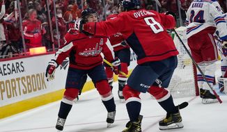 Washington Capitals right wing T.J. Oshie, left, celebrates with left wing Alex Ovechkin after Oshie&#39;s goal against the New York Rangers during the first period of an NHL hockey game Wednesday, Oct. 13, 2021, in Washington. (AP Photo/Alex Brandon)