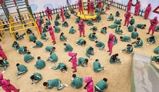 This undated photo released by Netflix shows a scene of contestants vying to win the Dalgona Korean candy challenge in a scene from &amp;quot;Squid Game.&amp;quot; Squid Game, a globally popular South Korea-produced Netflix show that depicts hundreds of financially distressed characters competing in deadly children’s games for a chance to escape severe debt, has struck a raw nerve at home, where there’s growing discontent over soaring household debt, decaying job markets and worsening income inequality. (Youngkyu Park/Netflix via AP)