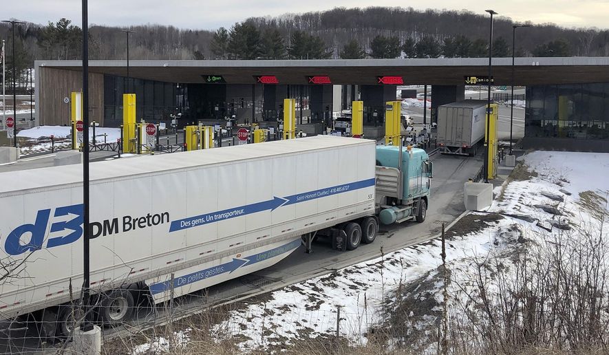 In this Wednesday, March 18, 2020, file photo, truck traffic from Canada waits to cross the border into the United States in Derby Line Vt. The U.S. will reopen its land borders to nonessential travel next month, ending a 19-month freeze due to the COVID-19 pandemic as the country moves to require all international visitors to be vaccinated against the coronavirus. The new rules, to be announced Wednesday, Oct. 13, 2021, will allow fully vaccinated foreign nationals to enter the U.S. regardless of the reason for travel (AP Photo/Wilson Ring, File)