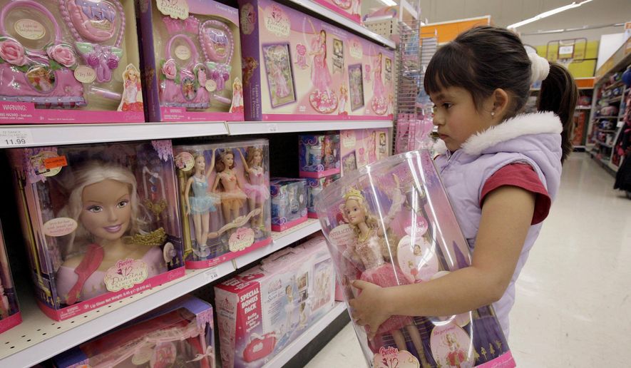 In this Jan. 29, 2007, file photo Yvette Ibarra holds a Dancing Princess Barbie doll while shopping at a toy store in Monrovia, Calif. Gov. Gavin Newsom signed 92% of the new laws lawmakers sent him at the end of this years legislative session that ended Sept. 10. One of the bills he approved makes California the first state to require large department stores to display products like toys and toothbrushes in gender-neutral ways. It does not outlaw traditional boys and girls sections at department stores, but says large stores must also have a gender-neutral section. (AP Photo/Nick Ut) **FILE**