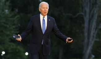 President Joe Biden gestures as he walks towards reporters on the South Lawn upon arrival at the White House in Washington, Friday, Oct. 15, 2021. (AP Photo/Manuel Balce Ceneta)
