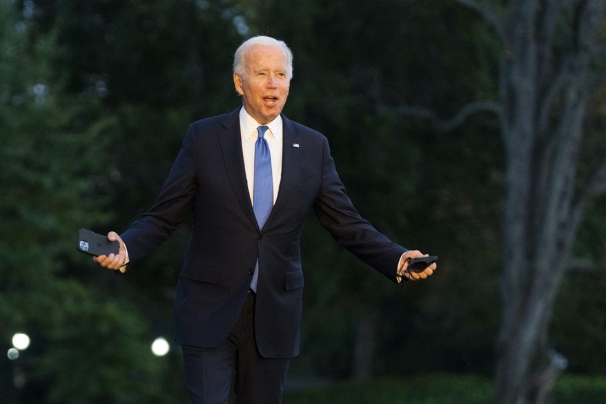 President Joe Biden gestures as he walks towards reporters on the South Lawn upon arrival at the White House in Washington, Friday, Oct. 15, 2021. (AP Photo/Manuel Balce Ceneta)