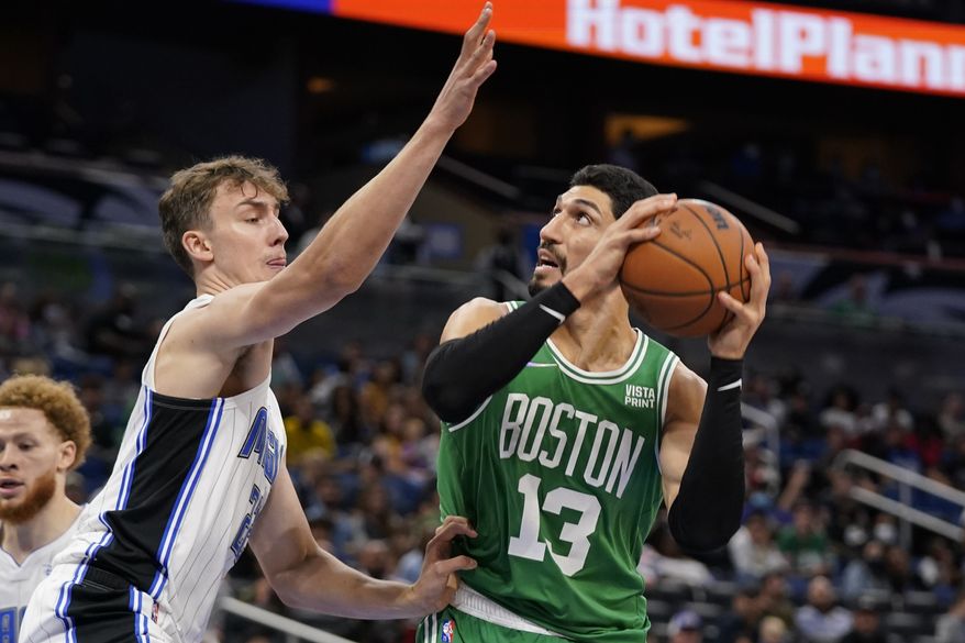 Boston Celtics&#x27; Enes Kanter (13) attempts a shot against Orlando Magic&#x27;s Franz Wagner, left, during the second half of an NBA preseason basketball game, Wednesday, Oct. 13, 2021, in Orlando, Fla. (AP Photo/John Raoux)