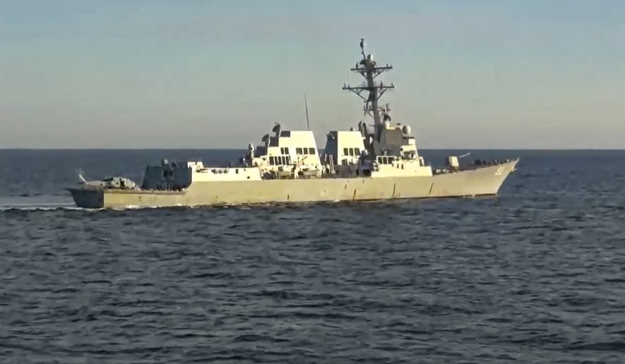 In this photo taken from a video released by Russian Defense Ministry Press Service, the U.S. destroyer USS Chafee is seen from the Russian navy&#x27;s Admiral Tributs destroyer near Russian territorial waters in the Sea of Japan on Friday, Oct. 15, 2021. (Russian Defense Ministry Press Service via AP)