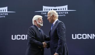 Former Sen. Chris Dodd, D-Conn., greets President Joe Biden as he arrives to speak at the dedication of the Dodd Center for Human Rights at the University of Connecticut, Friday, Oct. 15, 2021, in Storrs, Conn. (AP Photo/Evan Vucci) ** FILE **
