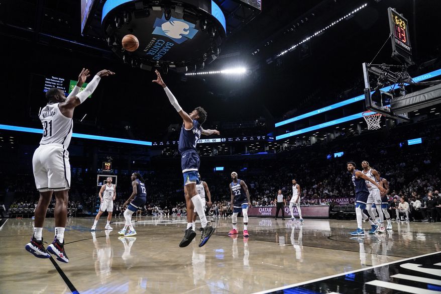 Brooklyn Nets&#39; Paul Millsap (31) shoots a 3-pointer over Minnesota Timberwolves&#39; Jaden McDaniels (3) during the second half of a preseason NBA basketball game Thursday, Oct. 14, 2021, in New York. (AP Photo/Frank Franklin II)