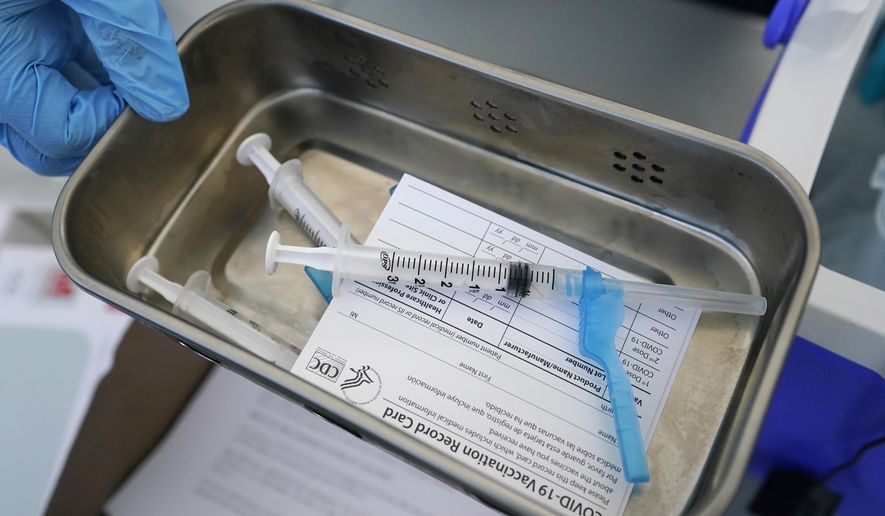 FILE - This May 13, 2021, file photo shows syringes filled with the Johnson &amp;amp; Johnson vaccine at a mobile vaccination site in Miami. Police departments that are requiring officers to be vaccinated against COVID-19 are running up against pockets of resistance across the U.S. (AP Photo/Wilfredo Lee, File)
