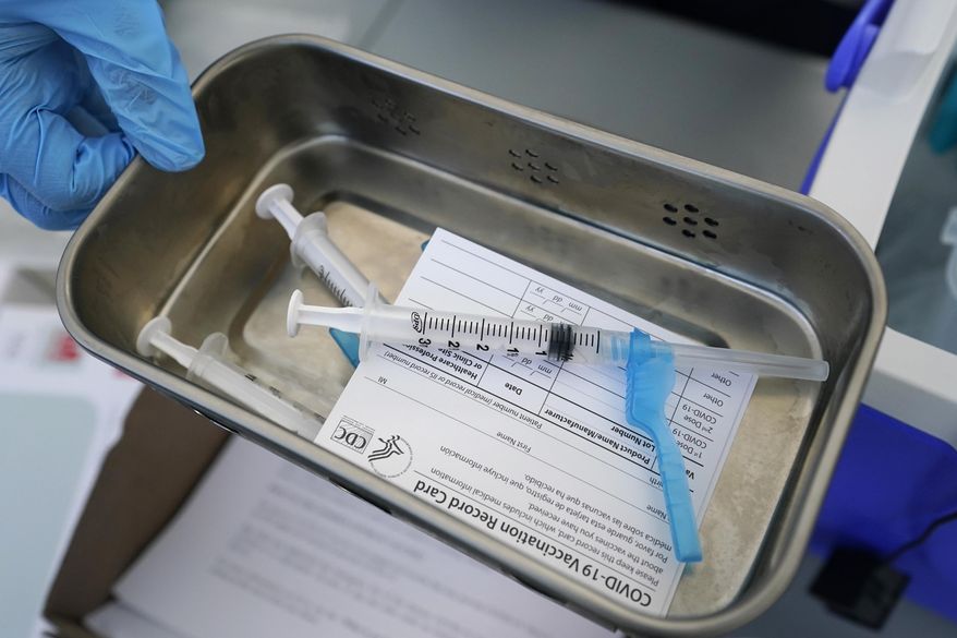 FILE - This May 13, 2021, file photo shows syringes filled with the Johnson &amp;amp; Johnson vaccine at a mobile vaccination site in Miami. Police departments that are requiring officers to be vaccinated against COVID-19 are running up against pockets of resistance across the U.S. (AP Photo/Wilfredo Lee, File)