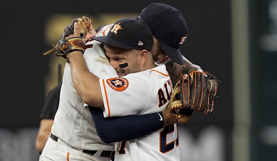Houston Astros shortstop Carlos Correa celebrates their win with Jose Altuve against the Boston Red Sox in Game 1 of baseball&#39;s American League Championship Series Friday, Oct. 15, 2021, in Houston. (AP Photo/David J. Phillip) **FILE**