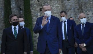 Turkey&#39;s President Recep Tayyip Erdogan, center, gestures to the media as he leaves after his meeting with German Chancellor Angela Merkel at Huber Villa presidential palace, in Istanbul, Turkey, Saturday, Oct. 16, 2021. The leaders discussed Ankara&#39;s relationship with Germany and the European Union as well as regional issues including Syria and Afghanistan. (AP Photo/Francisco Seco)